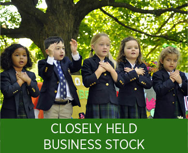Group of students doing the pledge of allegiance. Links to Closely Held Business Stock